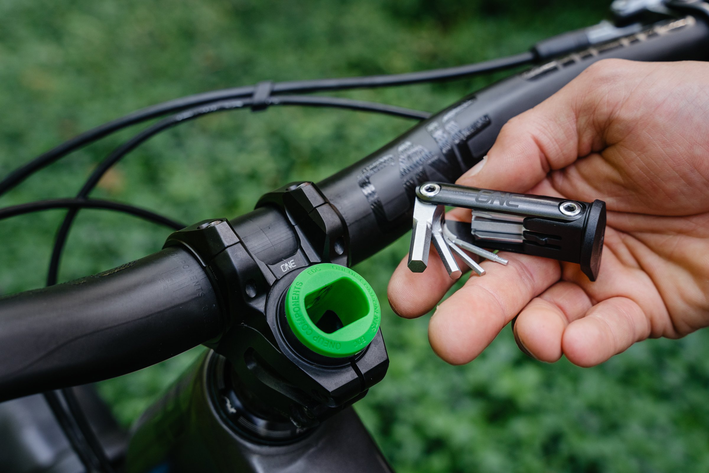 OneUp-Components-EDC-Lite-On-Bike-Multi-Tool-In-Hand-Green.jpg